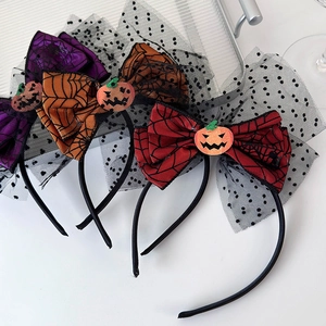 Detailed view of Halloween headband with orange pumpkin and spider web bow decoration