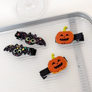Detail of Halloween hair clips with glitter bats and felt pumpkins on black clips