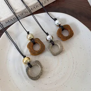 Retro camel bone style pendant necklace with metallic beads and adjustable black cord