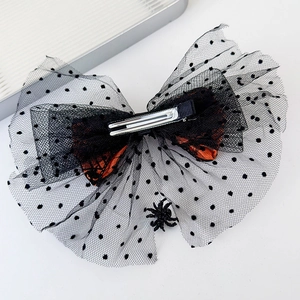 Detail of Halloween bow hair clip featuring black mesh lace and a small hanging spider