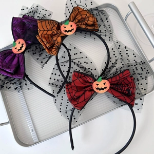Detail of Halloween headbands with mesh bows, spider patterns, and pumpkin accents