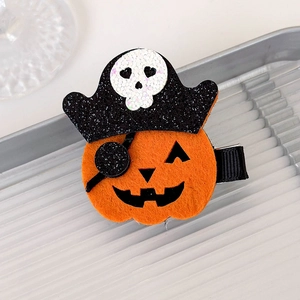 Detailed macro shot of a Halloween pumpkin pirate hair clip with glittery felt textures