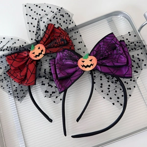Close-up of Halloween headbands with mesh bow, spider web texture and pumpkin design