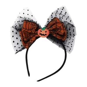 Close-up of Halloween headband featuring spider web bow and orange pumpkin motif