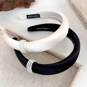 Elegant satin headbands in black and cream featuring triple-row pearl embellishments