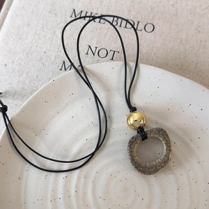 Detailed close-up of retro camel bone pendant with unique grey ice crackle glaze pattern