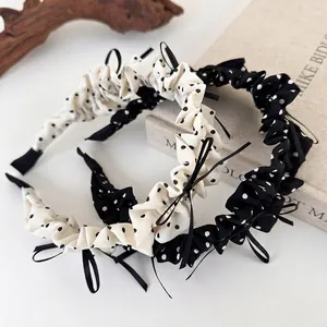 Retro style polka dot bow headband set in black and white with pleated fabric finish