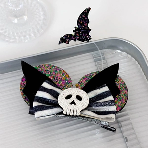 Detail of Halloween bow hair clip with white skull and glitter ears for cosplay party