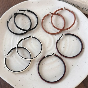 Set of large minimalist hoop earrings in brown, black, white and red leather texture