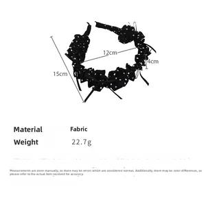 Detailed view showing dimensions and fabric texture of black polka dot bow headband