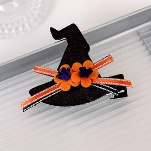 Detail of Halloween witch hat hair clip with orange flowers and striped ribbon bow on clip