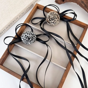 Eleganti elastici per capelli con rose leopardate e lunghi nastri di raso nero in vassoio