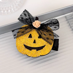 Detail of glitter pumpkin hair clip with black lace bow and pink rose for Halloween