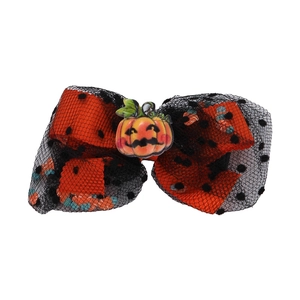 Close-up of Halloween hair bow with orange polka dots and a cute pumpkin centerpiece
