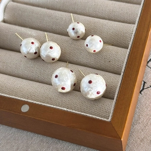 Elegant French style cotton pearl stud earrings with red polka dots on velvet tray