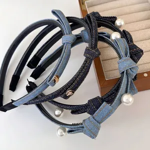 Denim bow headband for women with artificial pearls and golden accents in blue shades