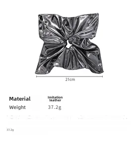 Close-up of metallic silver faux leather scrunchie with 21cm width and pleated texture
