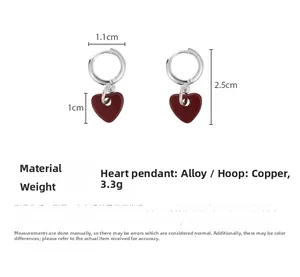 Detail view of red heart earrings showing dimensions and copper alloy material info