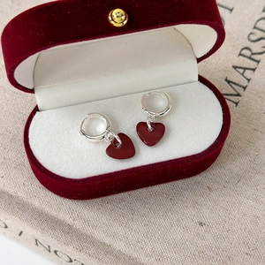 Elegant silver hoop earrings with dark red heart pendants in a velvet gift box