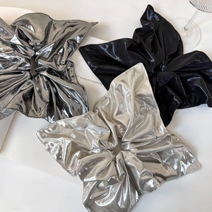 Chic metallic oversized scrunchies in silver and black with glossy pleated texture