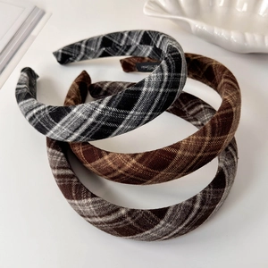 Detail of plaid fabric headbands with thick sponge padding and retro checkered pattern