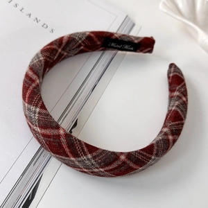 Detailed close-up of handmade retro plaid headband with vintage texture and inner label