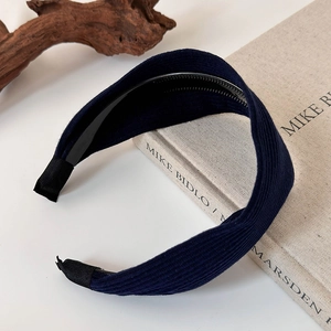 Detail view of navy blue ribbed knit wide headband with black non-slip inner teeth design