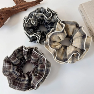 Three-piece set of vintage plaid scrunchies with elegant lace trim in classic brown and blue