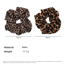 Detailed view of large leopard print scrunchies showing 16cm diameter and fabric texture