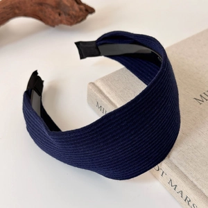 Detail view of navy blue ribbed knit wide headband with anti-slip inner teeth