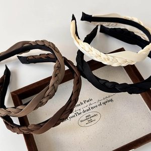 Set of four French vintage twisted satin headbands in neutral earth tones on a wooden tray