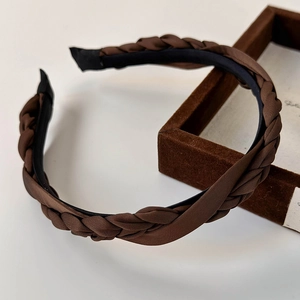 Detail of dark brown braided satin headband showing vintage twisted texture and finish