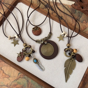 Vintage bohemian layered sweater necklaces with wooden beads and bronze feather pendants