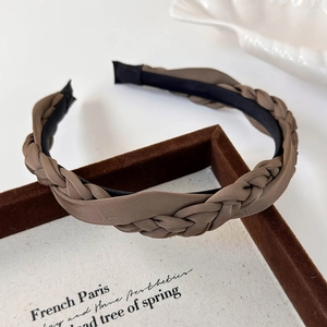 Close-up of deep brown braided satin headband with elegant French vintage texture