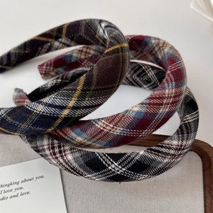 Detailed close-up of handmade plaid headbands in assorted classic checkered patterns