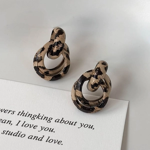 Close-up of vintage leopard print double hoop earrings with a textured animal pattern