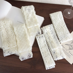 Macro view of five different white lace patterns on a rustic wooden background