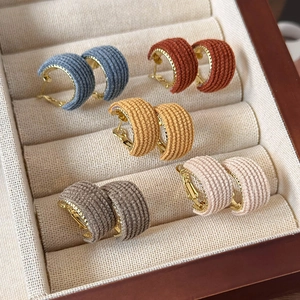 Knitted fabric wrapped C-shaped gold hoop earrings set in various vintage autumn colors