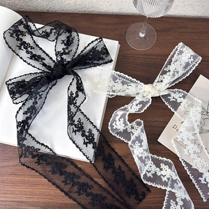 French retro floral lace hair ribbons in black and beige tied as elegant bows