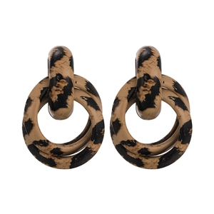 Detailed view of leopard print resin double-hoop earrings in vintage tortoise style