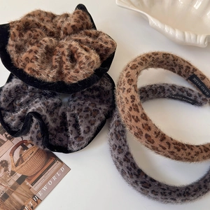Plush leopard print hair accessories set including headbands and scrunchies in fuzzy texture
