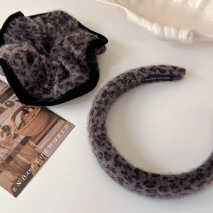 Detail of plush leopard print headband and scrunchie set with soft faux fur texture