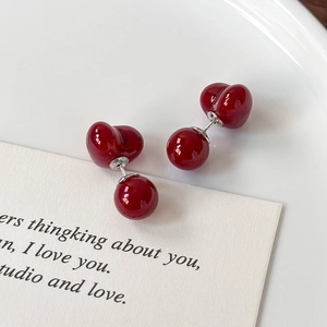 Elegant deep red cherry heart stud earrings with glossy finish on a minimalist background