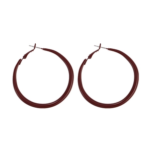 Macro shot of large dark red geometric hoop earrings with vintage matte finish