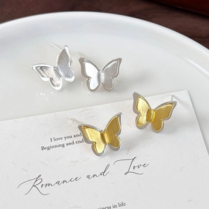 Brushed metal butterfly stud earrings with layered wings in silver and gold-tone finish