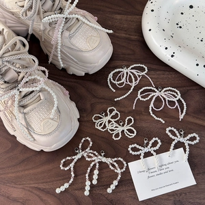 Dettaglio di fiocchi di perle e cristalli per decorare scarpe e sneaker da donna