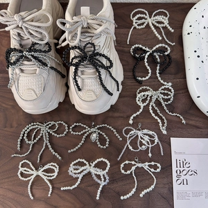 DIY handmade beaded bow shoe charms in pearl white, silver, and matte black for sneakers