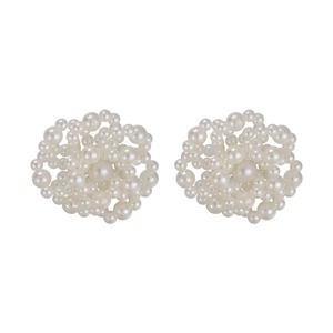 Detailed view of white faux pearl cluster stud earrings in a floral pattern arrangement