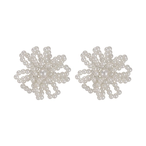 Close-up of white imitation pearl flower charms for shoe laces and elegant fashion accessories