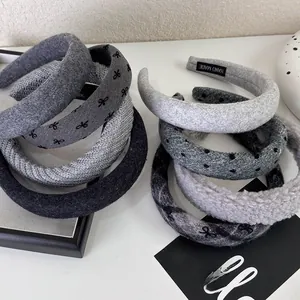 Close-up of assorted grey knitted headbands with diverse textures and patterns